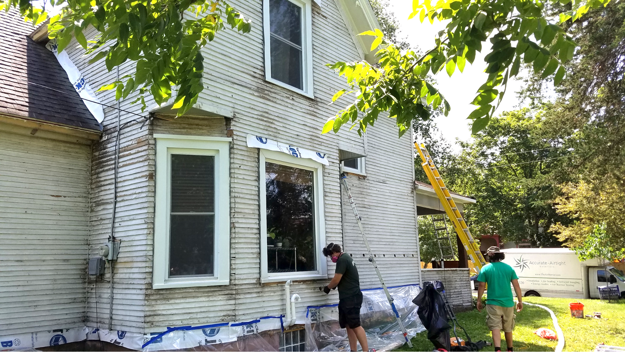 Accurate-Airtight Exteriors Crew Installing Insulation