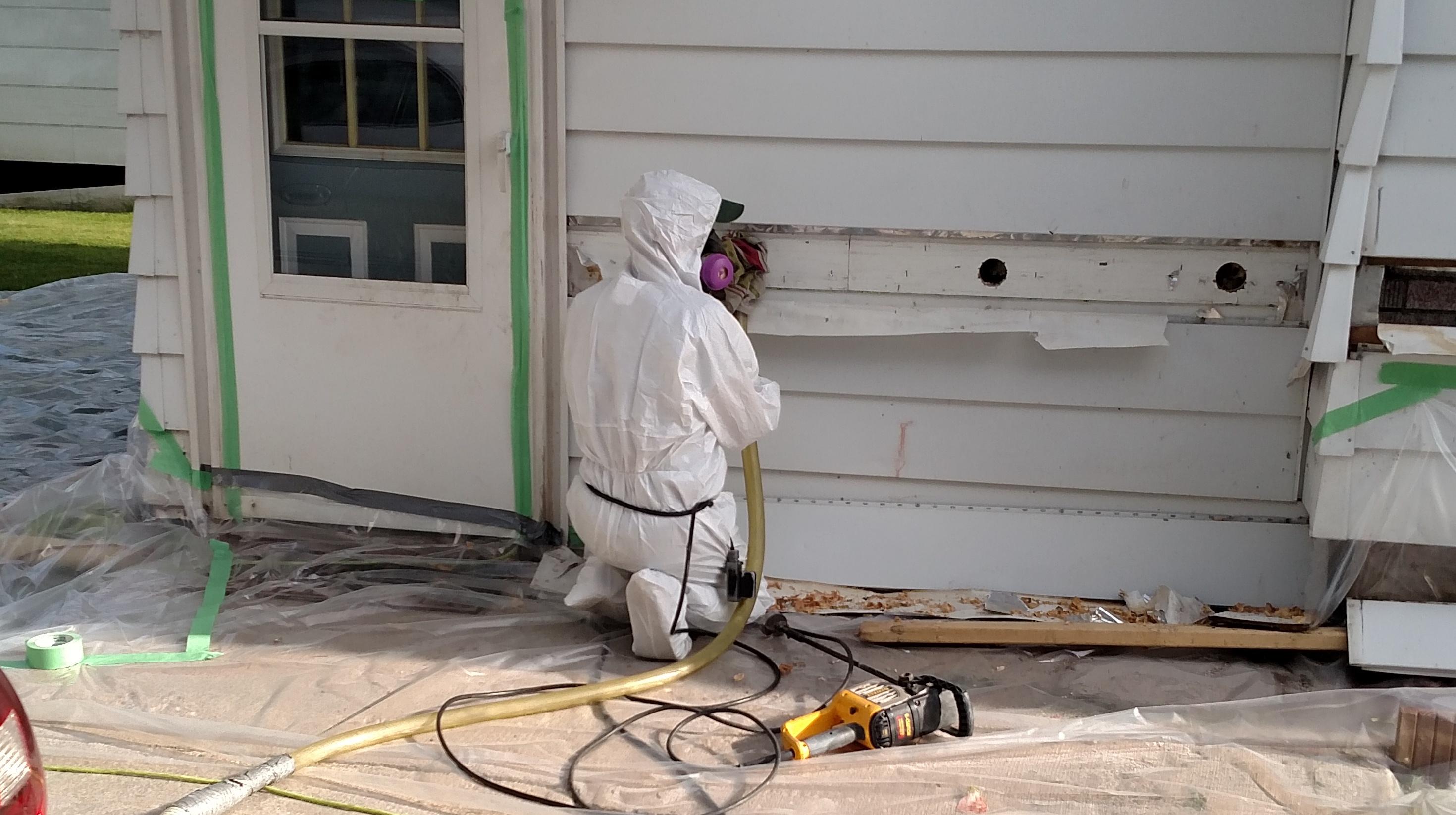 Blown Insulation Being Installed In Exterior Walls Of A House Blown Insulation Being Installed In Exterior Walls Of A House