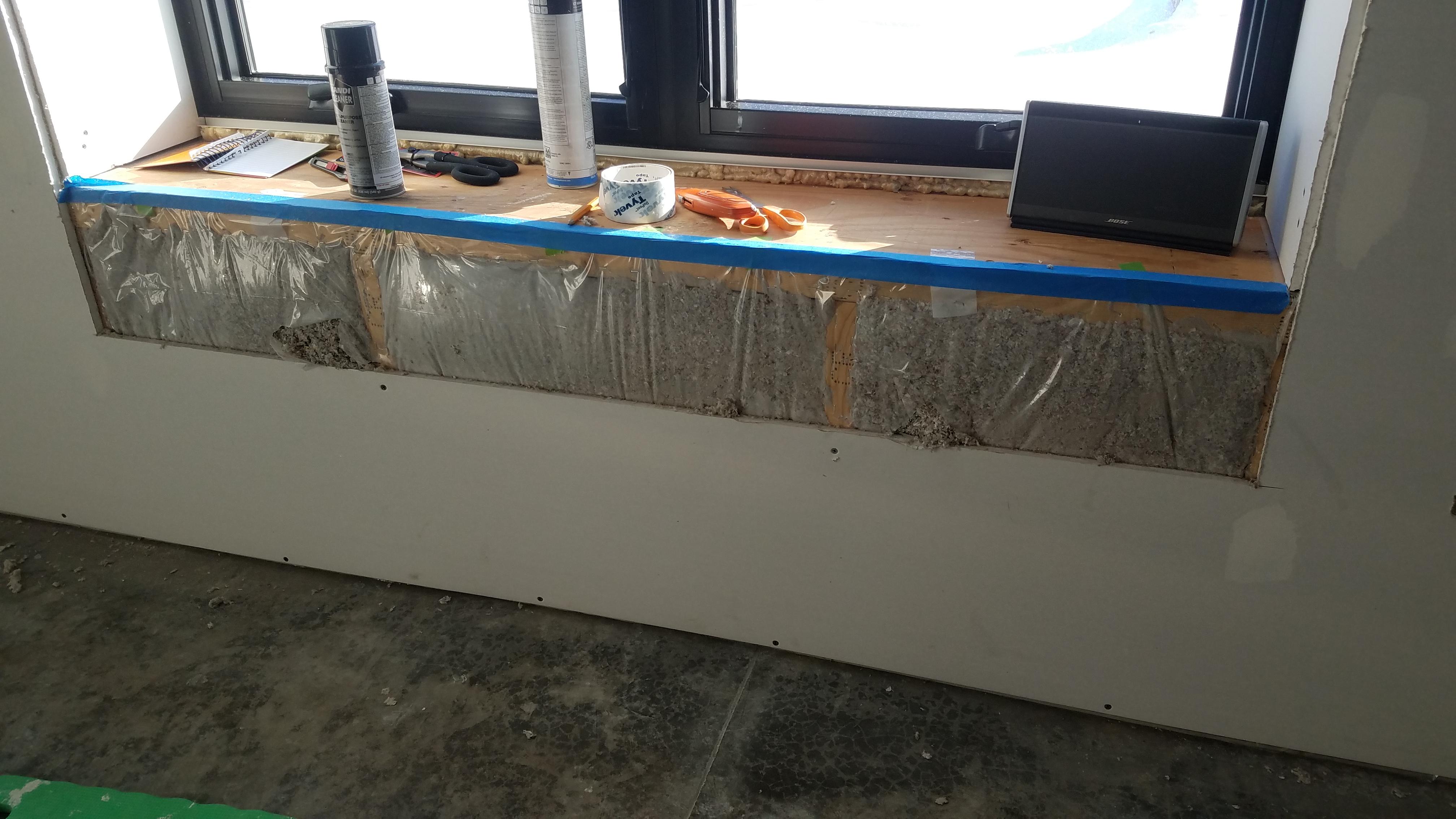 Window sill with freshly installed cellulose insulation
