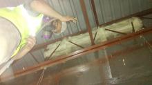 Technician Air Sealing Juncture Between Roof And Walls Technician Air Sealing Juncture Between Roof And Walls