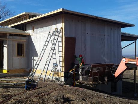 Exterior View Of New Construction House Site Where Insulation Work Is Being Done