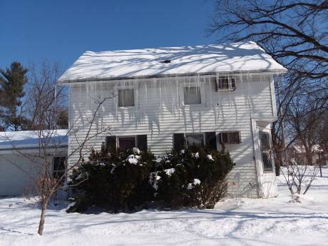House With Ice Dam In Winter