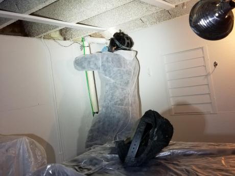 Accurate-Airtight Exteriors Crew Applying Spray Foam Insulation In Home