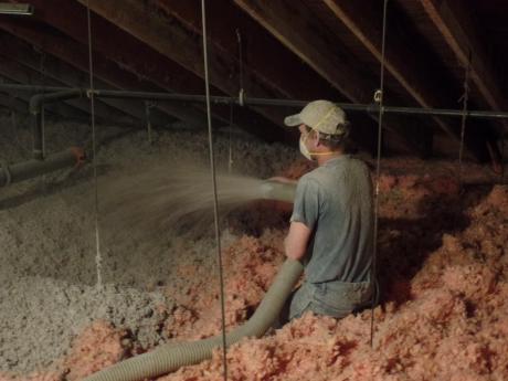 Crew Applying Blown Insulation In Attic 